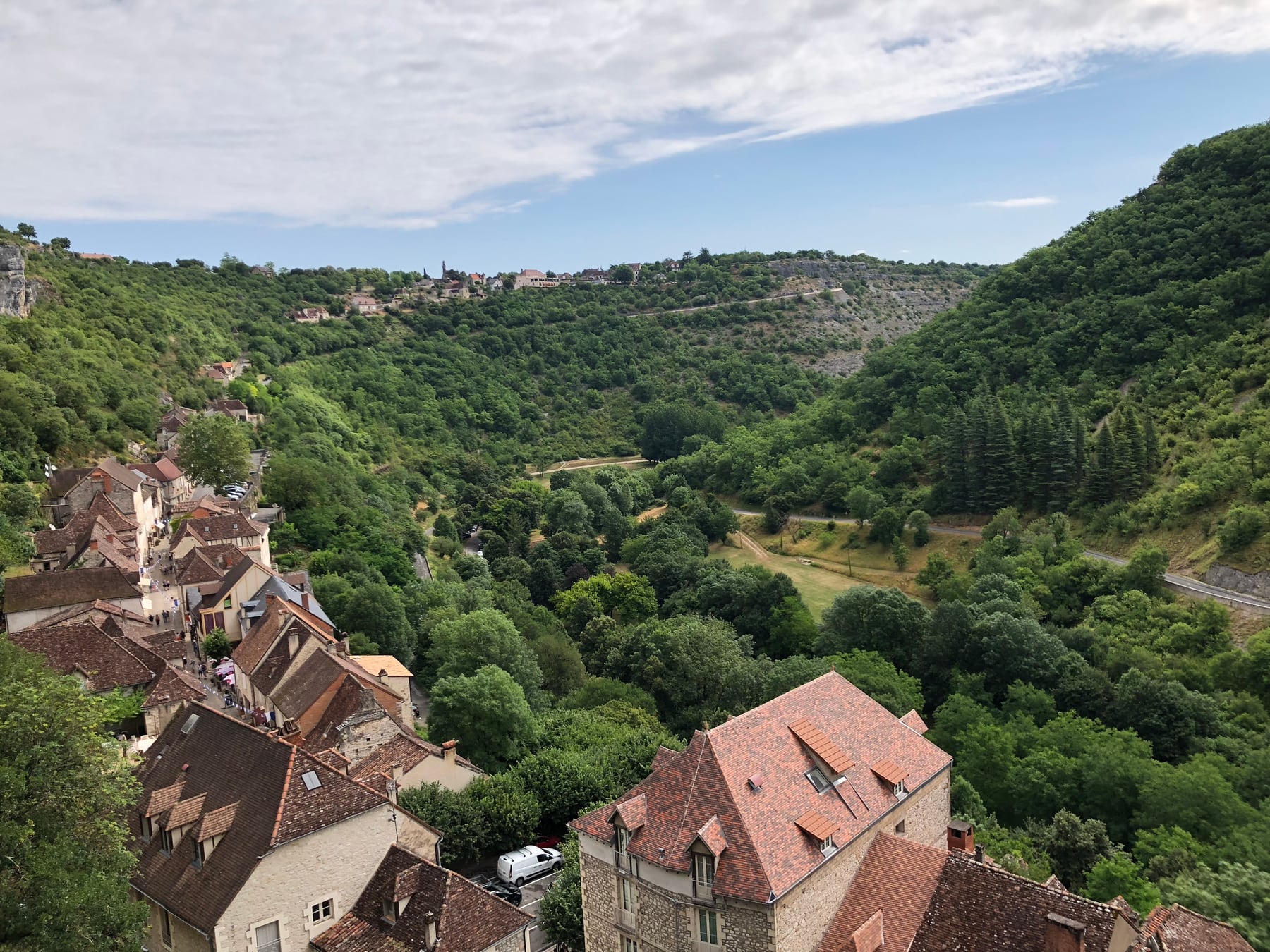 Red-roofed village tucked along a broad green valley
