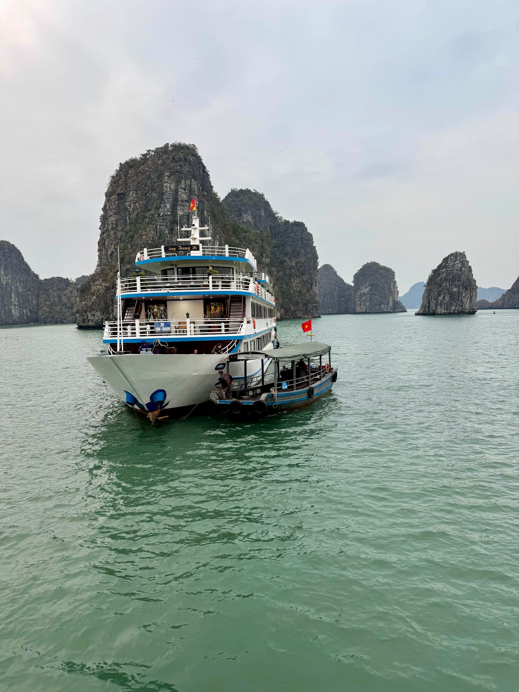 Passenger boat and tender surrounded by limestone islands